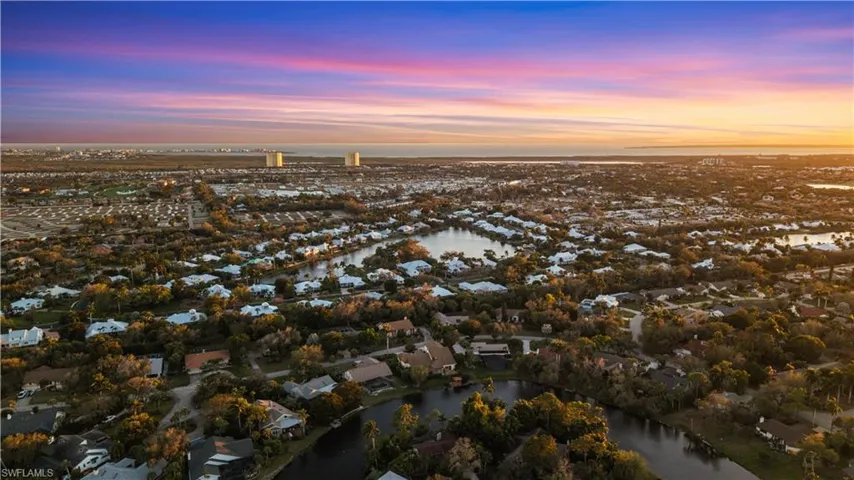 Aerial view at dusk of a water view and a residential view