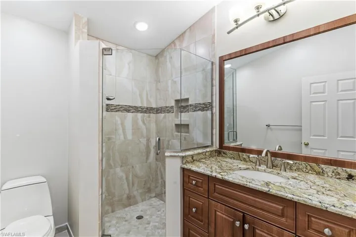 Full bathroom with a stall shower and vanity