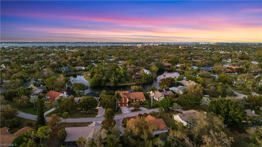 Aerial perspective of suburban area with a nearby body of water