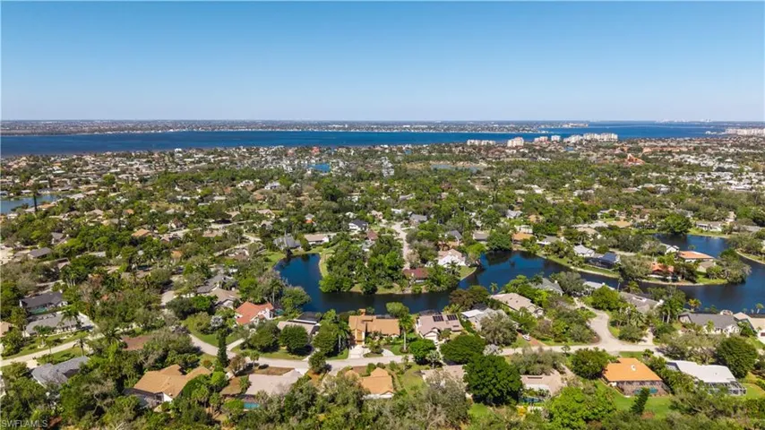 Aerial perspective of suburban area with a nearby body of water