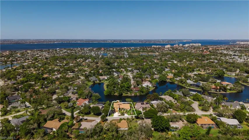 Aerial perspective of suburban area with a large body of water