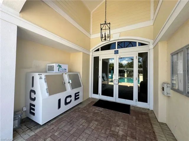 View of exterior entry featuring french doors and stucco siding