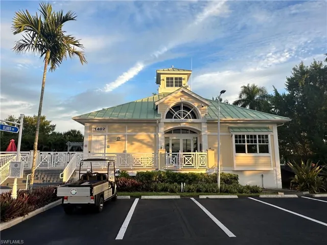 View of property featuring uncovered parking