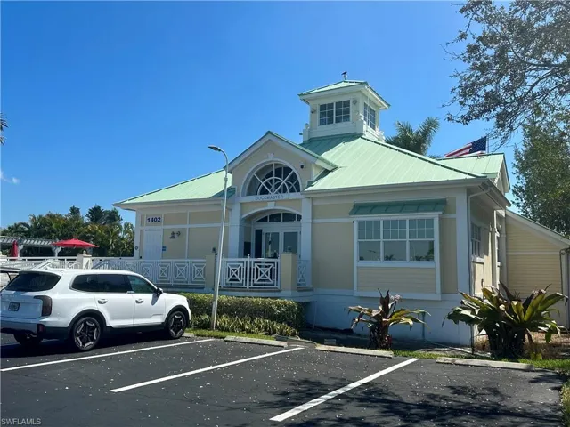 View of property featuring uncovered parking