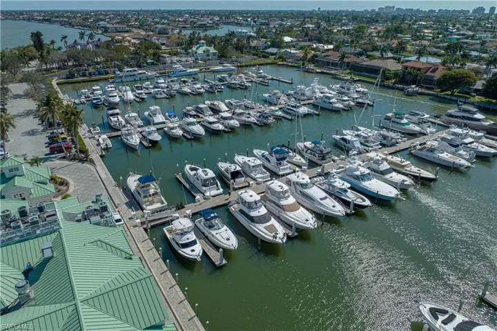Drone / aerial view of numerous boat docks and a large body of water