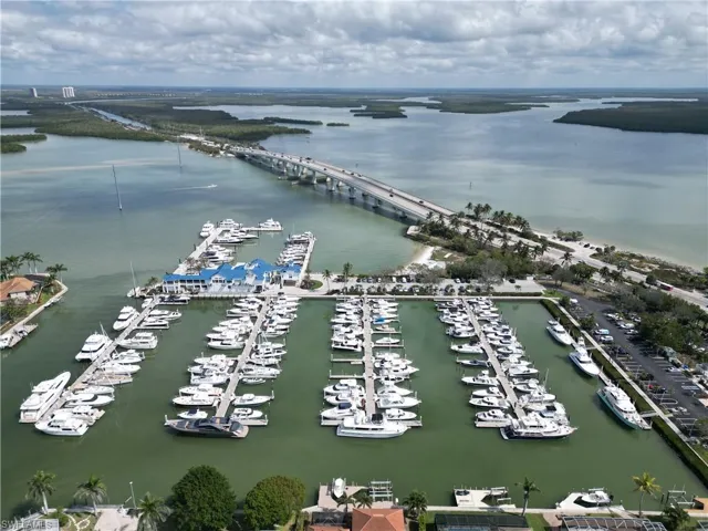 Drone / aerial view of a nearby body of water and a marina