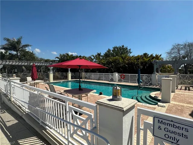 Community pool with a patio