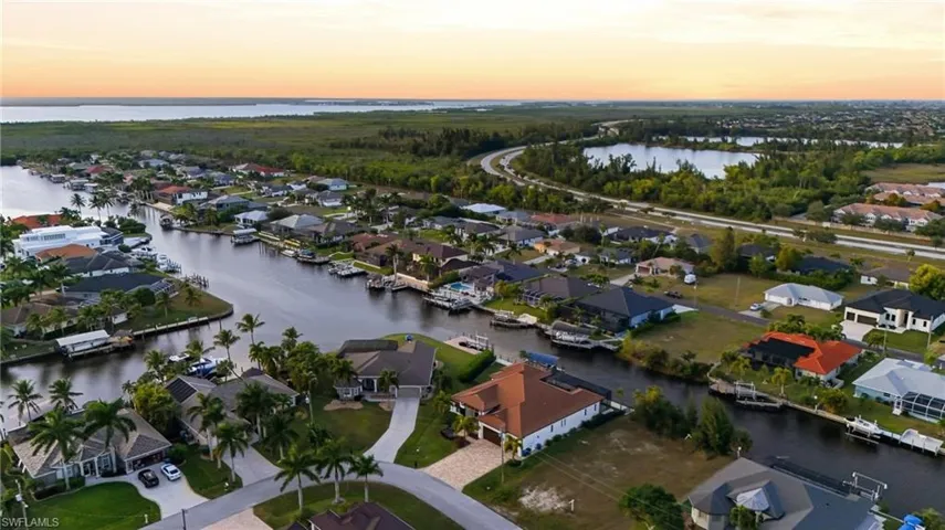 Aerial view of residential area featuring a nearby body of water