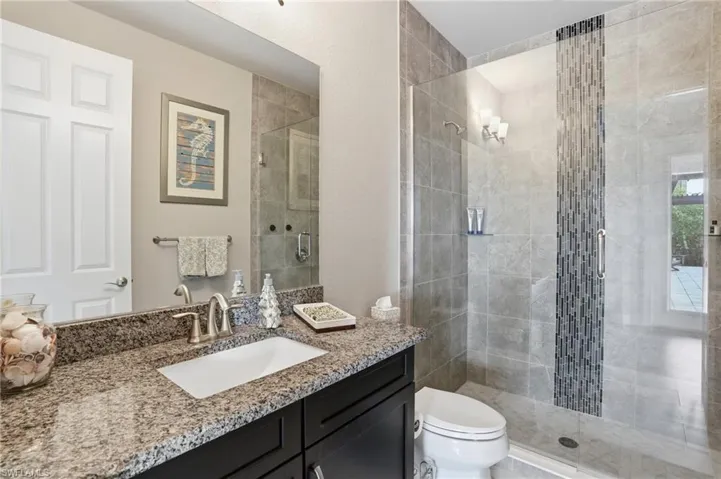 Full bathroom with a shower stall and vanity