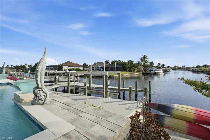 Dock area with boat lift and a water view