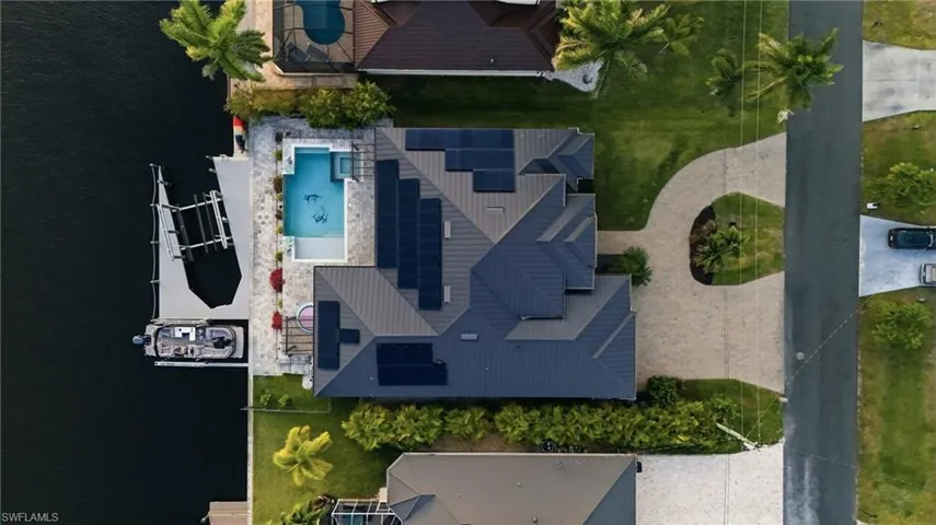 Bird's eye view of a pool area and a nearby body of water