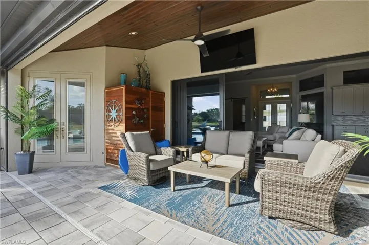 View of patio / terrace with french doors, an outdoor living space, and a ceiling fan
