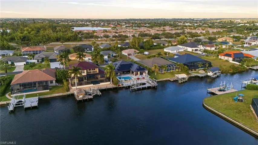 Aerial view at dusk of a water view and a residential view