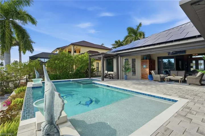 View of pool featuring a patio, an outdoor living space, a pool with connected hot tub, and a pergola