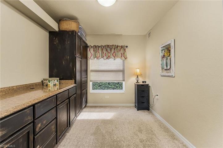 Den with built-in cabinets and closet