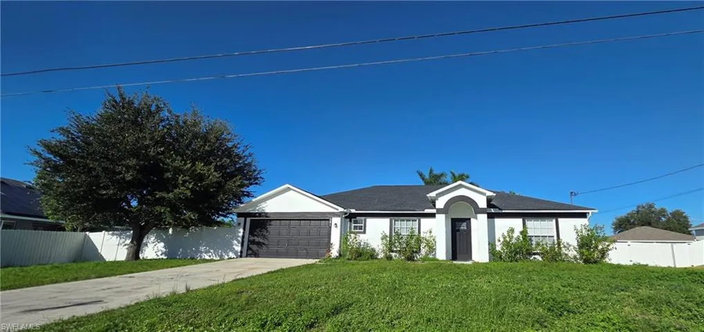 Contemporary exterior with a covered entry, attached garage, and a concrete driveway