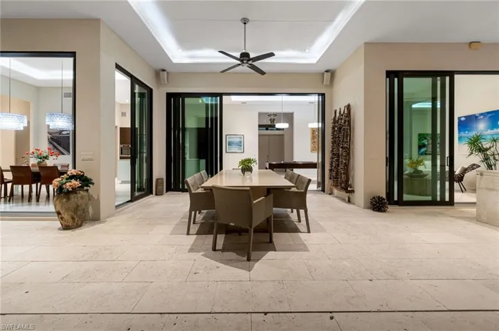Dining area with ceiling fan and a tray ceiling