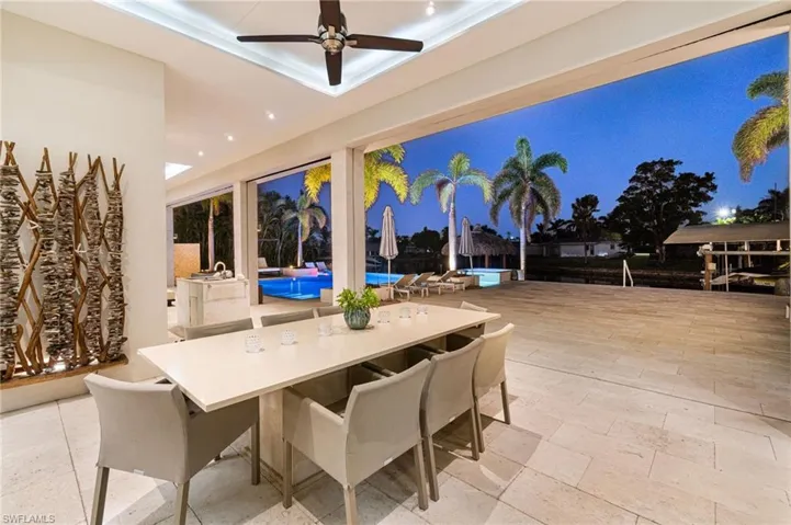 View of patio with a pool and ceiling fan
