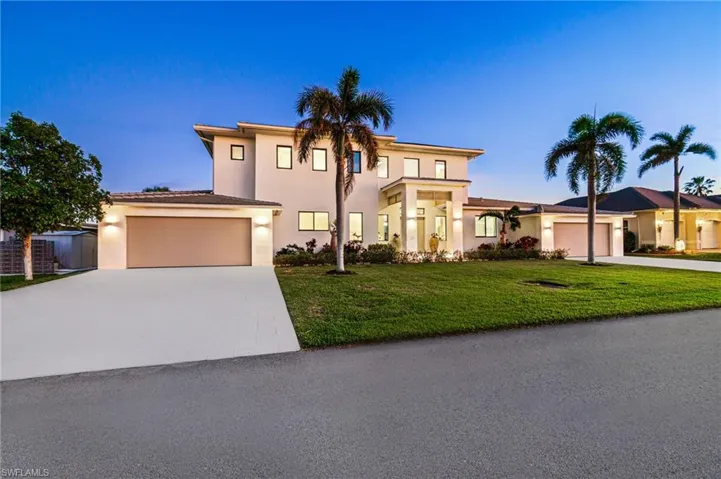 Mediterranean / spanish-style home featuring a yard and a garage