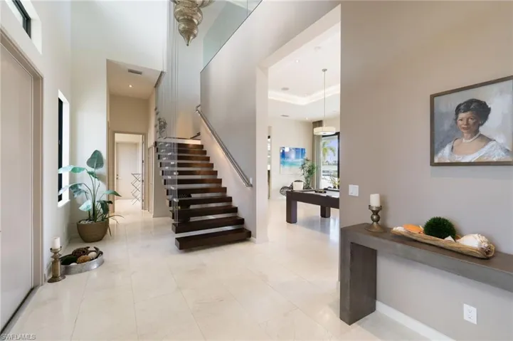 Foyer entrance with a high ceiling and a tray ceiling