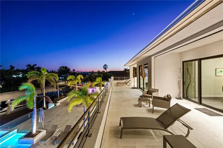 Patio terrace at dusk featuring a balcony