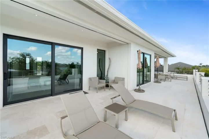 View of patio with a balcony