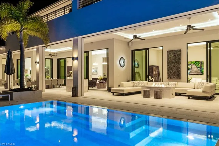 View of swimming pool with an outdoor living space, ceiling fan, and a patio
