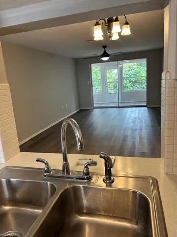 Kitchen view of a sink and wood finished floors