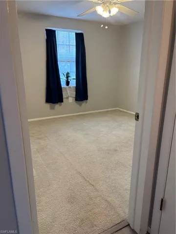 Guest Bedroom featuring light carpet and ceiling fan