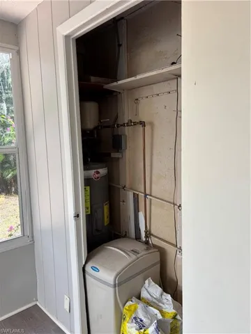 Utility room featuring water heater