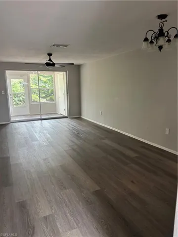Living/Doning Room Combo featuring wood finished floors and a chandelier