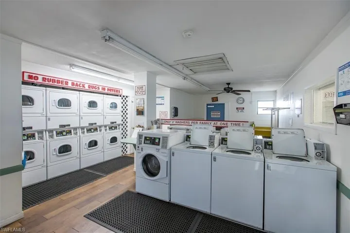 Communal laundry room with ceiling fan, washing machine and clothes dryer, and stacked washer / dryer
