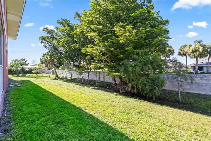Surrounded by lush, mature landscaping, the yard space around the building offers a tranquil, natural setting.
