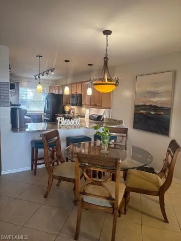 Dining room featuring light tile patterned floors and baseboards
