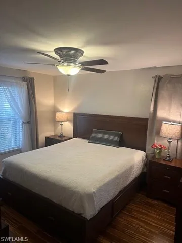 Bedroom featuring king size bedroom set with wood-style flooring and ceiling fan