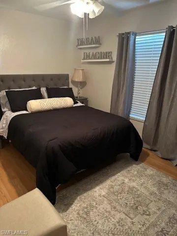 Second Bedroom has queen size bed, dresser, ceiling fan and wood finished floors