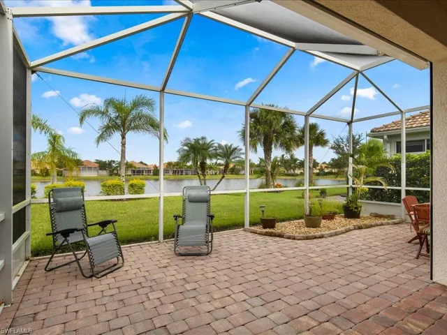 View of patio featuring a lanai and a water view