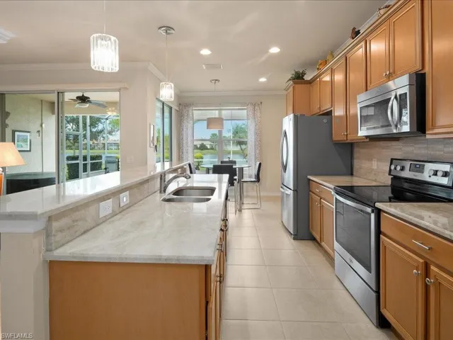 Kitchen featuring pendant lighting, appliances with stainless steel finishes, plenty of natural light, and sink