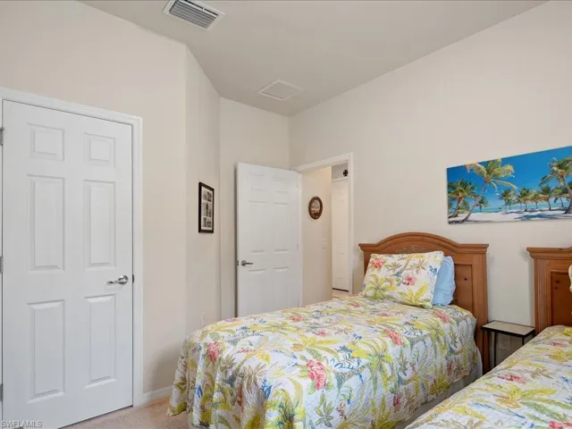 Bedroom featuring light carpet