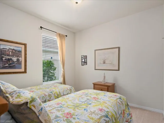 Bedroom featuring light carpet