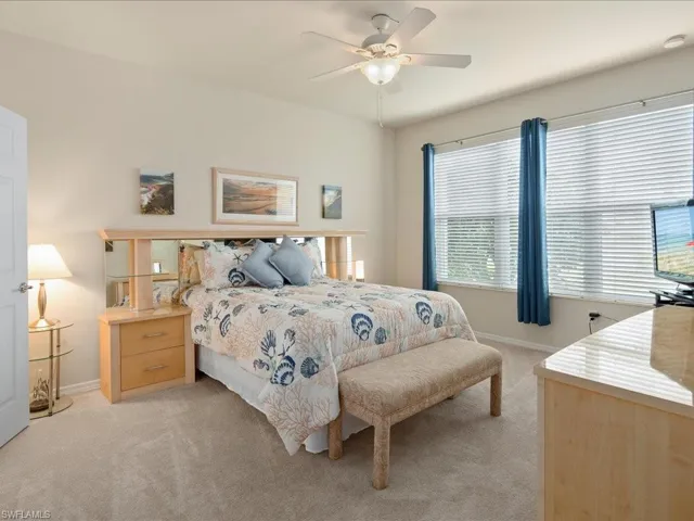 Carpeted bedroom with ceiling fan