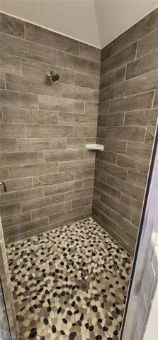 Full bath featuring a shower stall