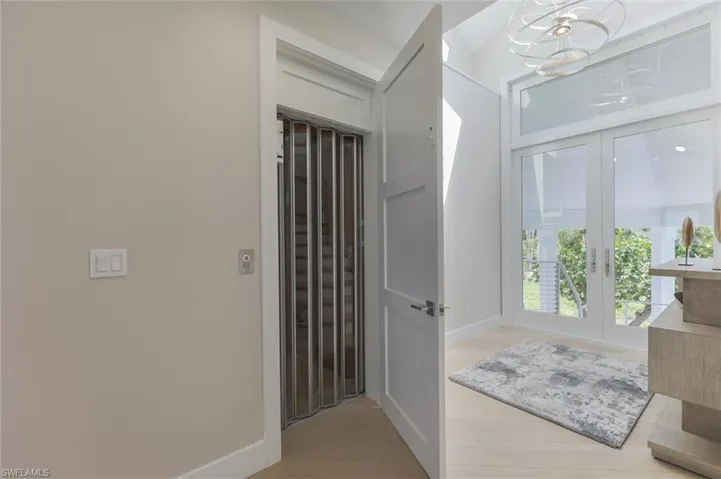 Bathroom featuring hardwood / wood-style floors and french doors