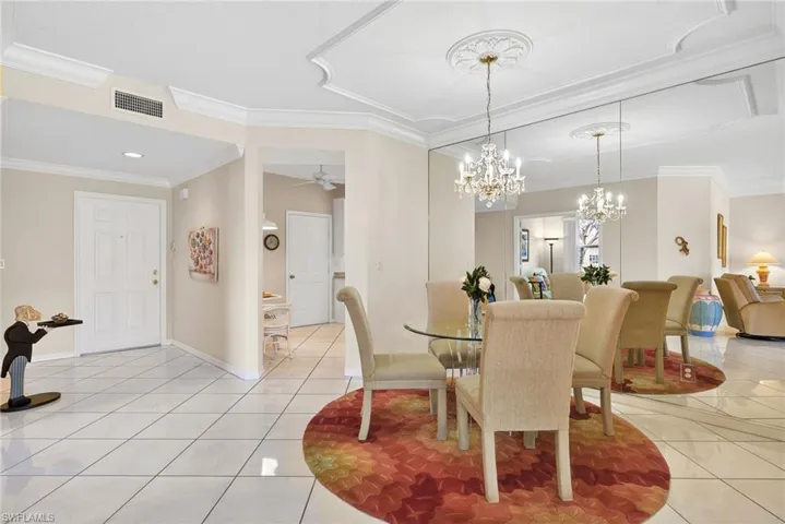 VIRTUALLY REFRESHED WITH A NEUTRAL PALETTE!  room with suspended lighting, crown molding, a ceiling fan, and light tile patterned floors