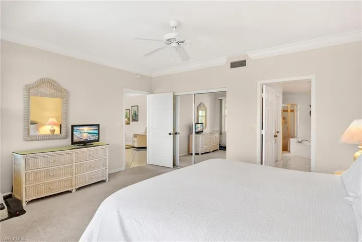 VIRTUALLY REFRESHED WITH A NEUTRAL PALETTE!  with ornamental molding, light colored carpet, ceiling fan, a closet, and ensuite bath