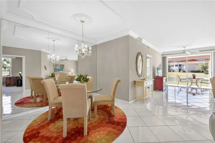 VIRTUALLY REFRESHED WITH A NEUTRAL PALETTE!  area featuring ornamental molding, light tile patterned floors, suspended lighting, and a ceiling fan