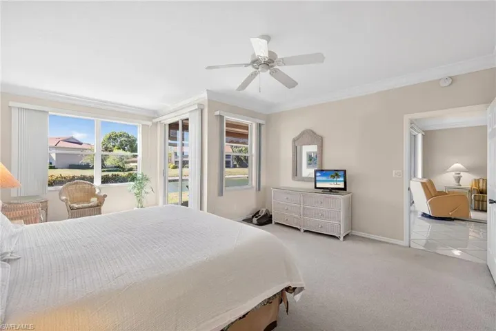 VIRTUALLY REFRESHED WITH A NEUTRAL PALETTE!  featuring light carpet, a ceiling fan, access to exterior, and crown molding