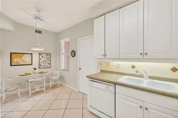 VIRTUALLY REFRESHED WITH A NEUTRAL PALETTE!  with white cabinets, dishwasher, decorative light fixtures, dark countertops, and a ceiling fan