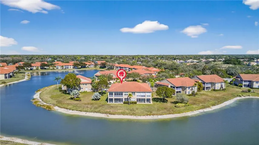 Aerial view of residential area featuring a large body of water