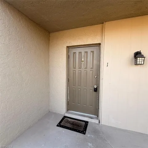 Entrance to property with stucco siding